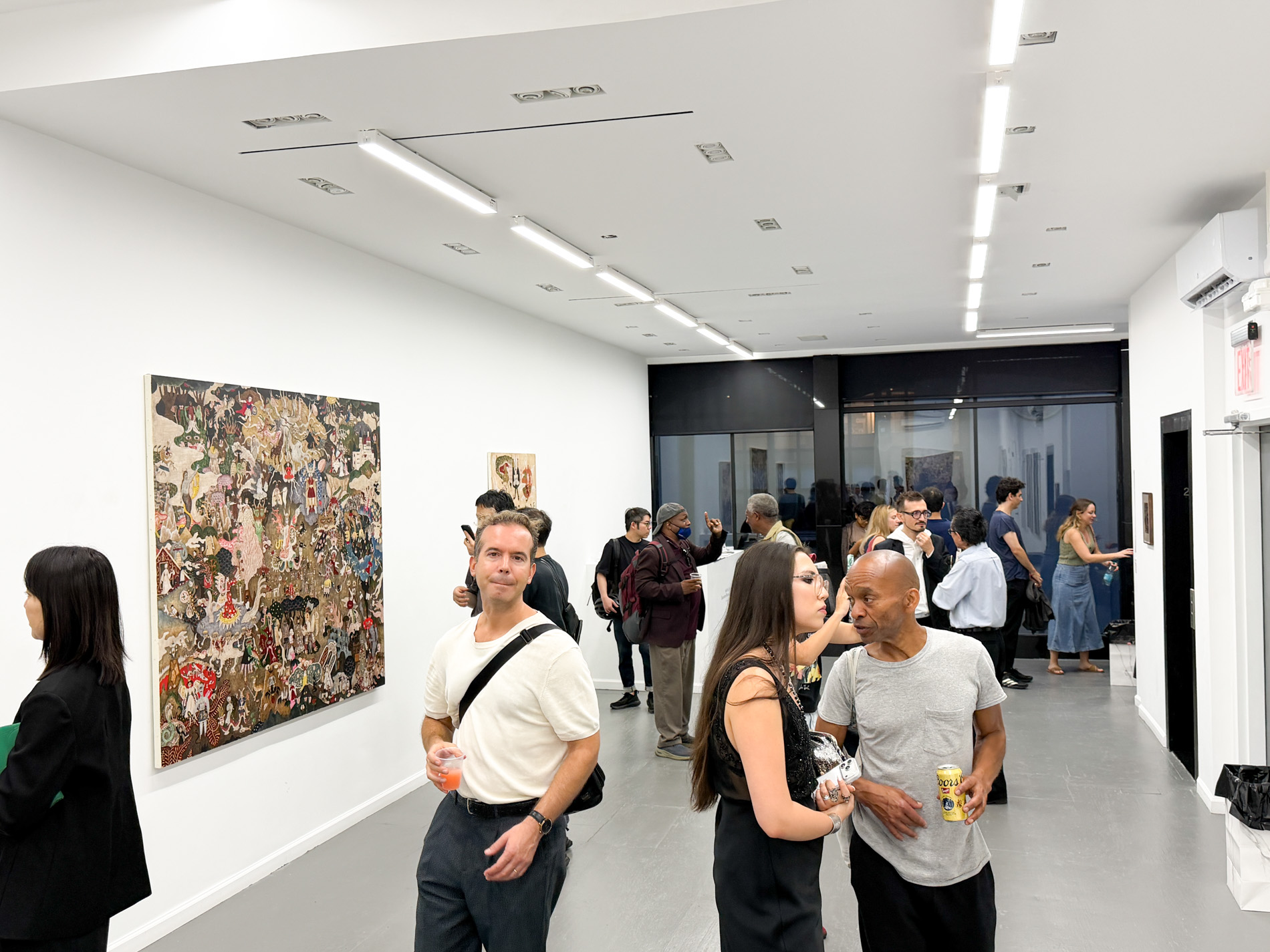 GR gallery の会場風景。壁に網代幸介の大作が掛かり、来場者が集まっている